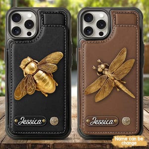 May include: Two phone cases with a leather wallet design. One is black with a gold bee, the other is brown with a gold dragonfly. Both cases have the name "Jessica" and the text "Name can be change".