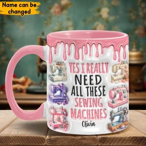 May include: Pink ceramic coffee mug with a white design featuring a dripping effect and multiple sewing machines. The text reads "Yes I really need all these sewing machines Olivia".