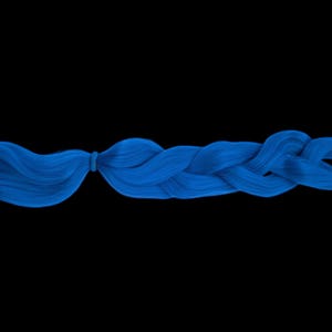 May include: A striking blue braid against a black backdrop. The braid is carefully styled, with a section of hair secured with a small elastic band. The hair is a vivid, saturated blue colour.