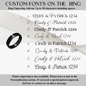 May include: A black ring with engraved text, shown with font options for customisation. The text includes names and numbers. The image also features the text "CUSTOM FONTS ON THE RING" and "Ring Engraving Add-on: Up to 30 characters including spaces."