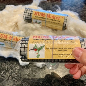 May include: Three packages of Hummingbird Nesting Material, each containing a roll of organic cotton. The packages are labeled "HUM-Maker" and include instructions for use. The text on the package reads: "Hummingbird Nesting Material, Clings to Window or clips to any surface, Hand-meal feeders to offer birds material, Organic Cotton, PlantWhisperer42@hotmail.com, 203.142 7734."