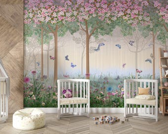 May include: A white crib with a canopy, two white chairs, and a white beanbag chair in a nursery with a floral wallpaper featuring a forest scene with pink flowers and butterflies.