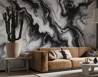 May include: A brown leather sofa with black and white abstract marble wallpaper in the background. The sofa has pillows and is in a living room setting.