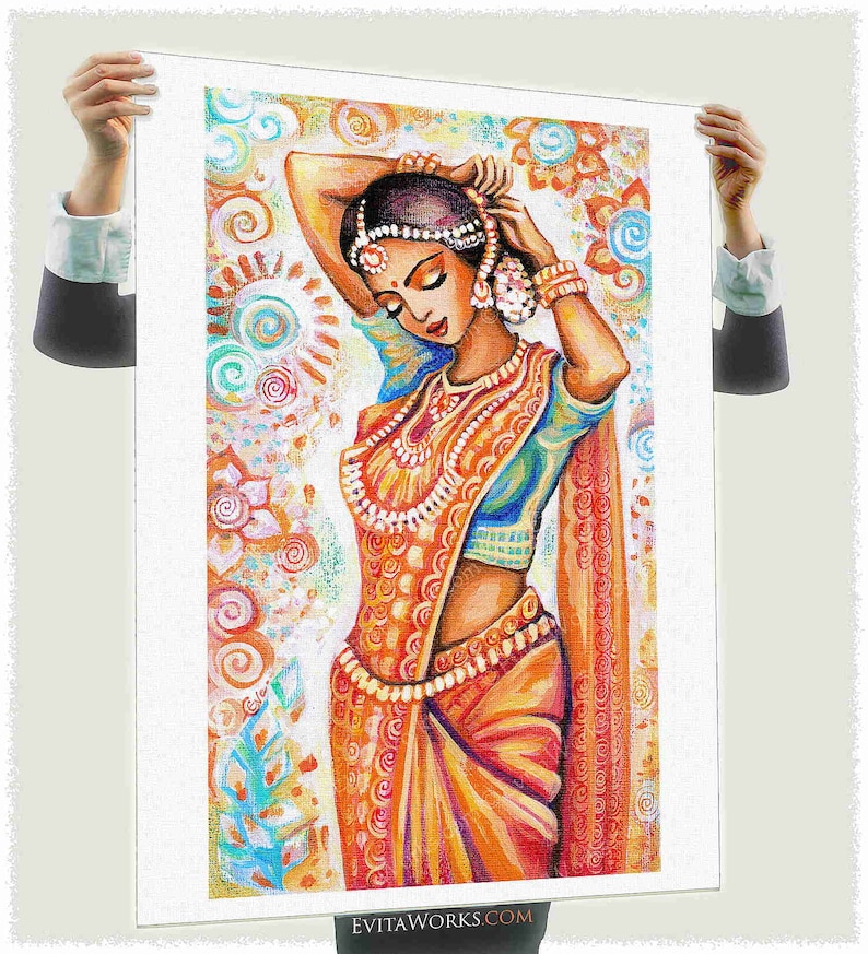 May include: An artistic print of a woman in traditional Indian attire. The artwork features a woman in an orange sari with intricate gold jewelry, set against a backdrop of colorful floral patterns. The woman is depicted with her hands raised, adjusting her headpiece.