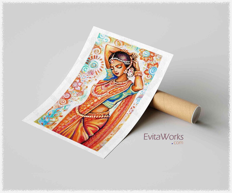 May include: A colorful watercolor print of a woman in traditional Indian attire. The artwork features a woman in a vibrant orange and blue sari, adorned with jewelry. The background has floral and paisley patterns. The print is leaning against a brown cardboard tube.