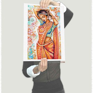 May include: An artistic print of a woman in traditional Indian attire. The woman is adorned with jewelry and a vibrant orange sari. The background features colorful floral patterns. The website address is visible at the bottom.