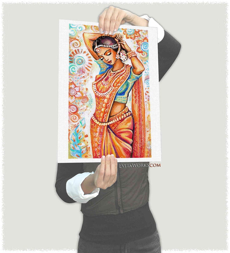 May include: An artistic print of a woman in traditional Indian attire. The woman is adorned with jewelry and a vibrant orange sari. The background features colorful floral patterns. The website address is visible at the bottom.