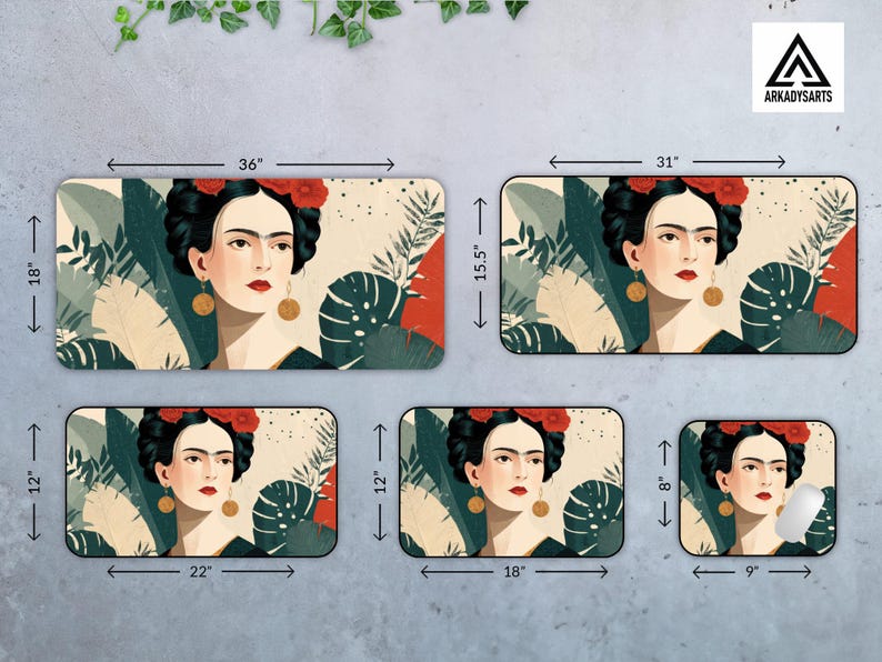 May include: Rectangular desk mats featuring a portrait of Frida Kahlo with red flowers in her hair, gold earrings, and a black dress. The mats are available in various sizes, with the largest measuring 36 inches by 18 inches.