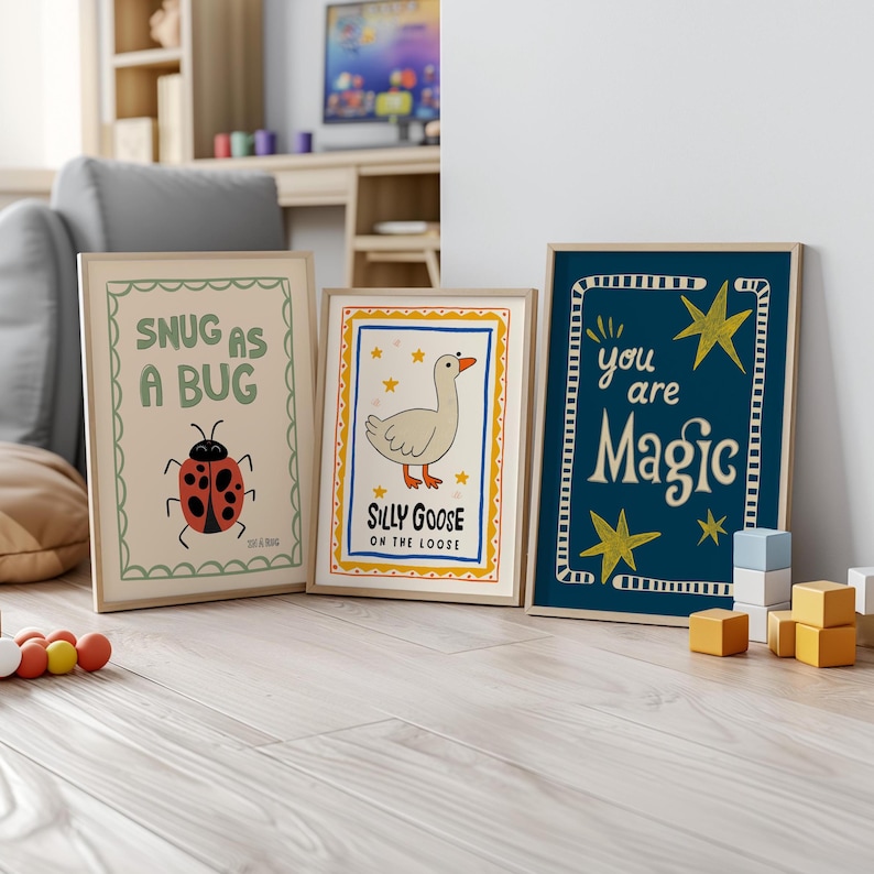 May include: Three framed art prints with whimsical designs. One features a ladybug and the text "Snug as a Bug." Another shows a goose with the words "Silly Goose on the Loose." The third print says "You are Magic" with star accents.
