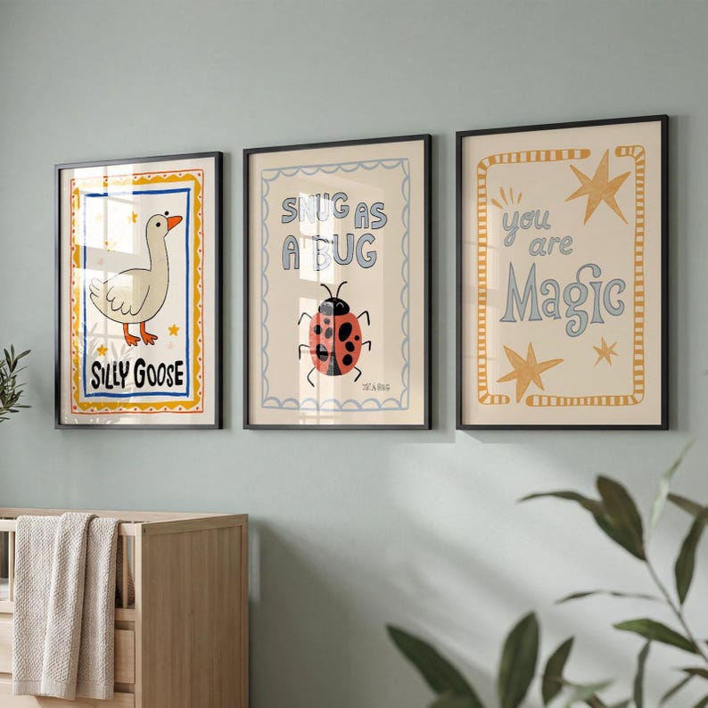May include: Three framed art prints with whimsical designs. One features a goose with the text "Silly Goose", another a ladybug with "Snug as a Bug", and the last with stars and "You are Magic".