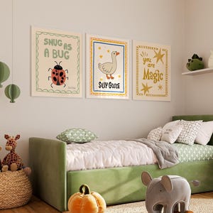 May include: Three framed art prints with whimsical illustrations and text. The first print says "Snug as a Bug" with a ladybug. The second print says "Silly Goose" with a goose. The third print says "You are Magic".