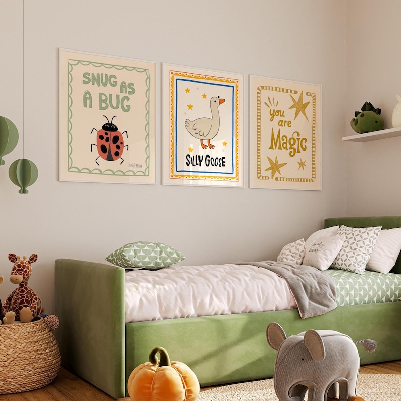 May include: Three framed art prints with whimsical illustrations and text. The first print says "Snug as a Bug" with a ladybug. The second print says "Silly Goose" with a goose. The third print says "You are Magic".
