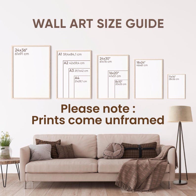 May include: Wall art size guide with framed examples, including sizes like 24x36 inches (61x91 cm) and 11x14 inches (28x36 cm). The text "Please note: Prints come unframed" is also displayed. A sofa, pillows, and a floor lamp are in the foreground.