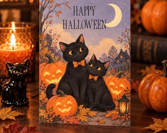 May include: A rectangular greeting card featuring two black cats wearing orange polka-dot bow ties, sitting among jack-o'-lanterns and autumn leaves. The text "HAPPY HALLOWEEN" is printed at the top under a crescent moon in a night sky.