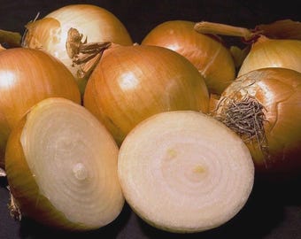 May include: A collection of yellow and brown onions, some whole and some sliced in half, revealing the white interior. The onions are arranged on a dark surface, showcasing their layered texture and natural colors. A common ingredient in many cuisines.