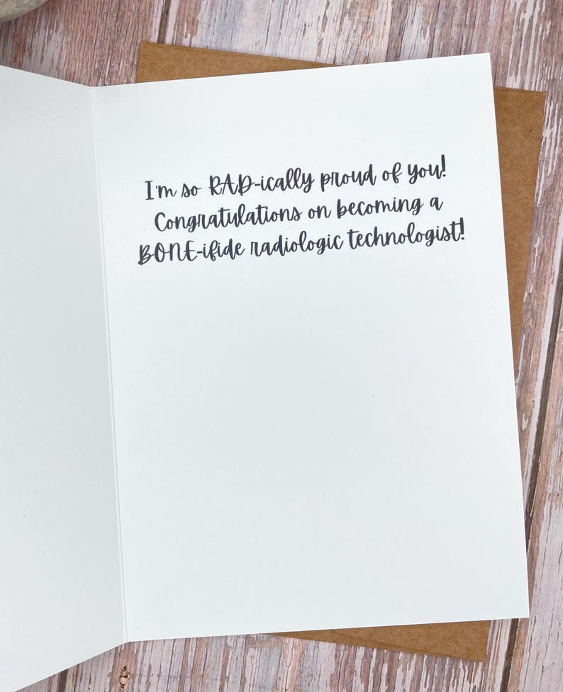 May include: A white greeting card with the text "I'm so RAD-ically proud of you! Congratulations on becoming a BONE-ifide radiologic technologist!" The card is inside a brown envelope.