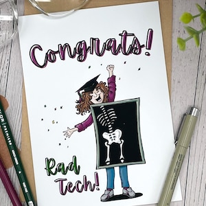 May include: A graduation card with the word "Congrats!" in purple script. The card features a cartoon illustration of a graduate wearing a cap and holding a sign with a skeleton image. The words "Rad Tech!" are written in green.