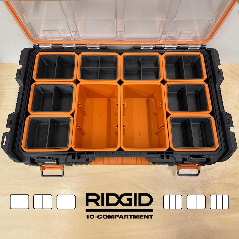 Puede incluir: Un organizador de herramientas Ridgid negro y naranja de 10 compartimentos con tapa transparente. El organizador tiene m&uacute;ltiples compartimentos de varios tama&ntilde;os, con interior naranja y negro. El logotipo de Ridgid y el texto "10-compartimentos" son visibles.
