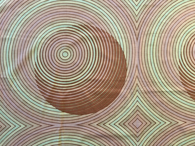May include: Abstract pattern with concentric circles in shades of brown, pink, and green. The circles are layered on top of each other, creating a sense of depth and movement.