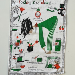 May include: A white tea towel with a black border and a colorful illustration of a woman doing various household chores. The text "y...todos los dias..." is printed at the top of the towel.