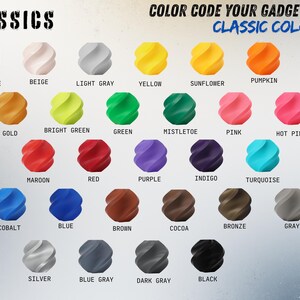 May include: A colour chart showcasing 28 different colours, each represented by a 3D-printed, spiral-shaped object. Colours include Jade White, Beige, Light Grey, Yellow, Sunflower, Pumpkin, Orange, Gold, Bright Green, Green, Mistletoe, Pink, Hot Pink, Magenta, Maroon, Red, Purple, Indigo, Turquoise, Cyan, Cobalt, Blue, Brown, Cocoa, Bronze, Grey, Silver, Blue Grey, Dark Grey, and Black.