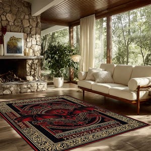 May include: A rectangular area rug with a dragon design. The rug features a black background with a red dragon in the center, surrounded by roses and gold accents. The rug is placed on a wooden floor in a living room.