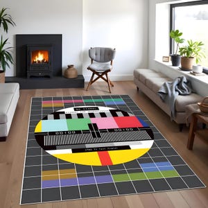 May include: A black and white rug with a colourful TV test pattern in the centre. The pattern includes the text "NO SIGNAL STANDBY FOR TRANSMISSION 1940 TV Test Signal".
