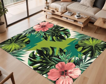 May include: A tropical-themed rug with a white background and a repeating pattern of large green leaves and pink hibiscus flowers.