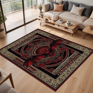 May include: A rectangular area rug with a gothic design. The rug features a central image of a red bat with outstretched wings, surrounded by roses and ornate patterns. The border is black with gold accents and a repeating pattern. The rug is placed on a hardwood floor.