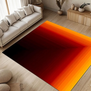 May include: A black and orange area rug with a gradient design. The rug has a square shape with a black center that fades into orange and yellow at the edges.