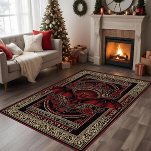 May include: A rectangular area rug with a gothic design featuring a red bat with outstretched wings, roses, and a circular emblem on a black background. The rug has a gold border with runic symbols and is placed in a living room.