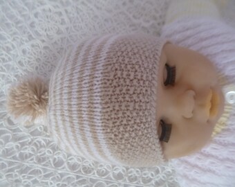 Newborn Beanie Hat, Hand Knitted with Soft Hypoallergenic Wool. The Color is Camel and White.