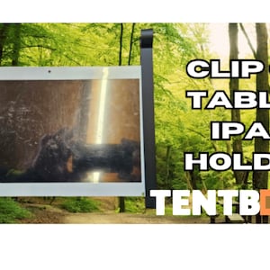 May include: A black clip-on tablet/iPad holder with the text "CLIP ON TABLET IPAD HOLDER" and the brand name "TENTBOX" in white. The background is a blurred image of a forest.
