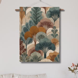 May include: A wall hanging featuring a stylized forest scene with trees in shades of teal, brown, and gold against a beige background. The artwork is mounted on a wooden rod and suspended by a string.