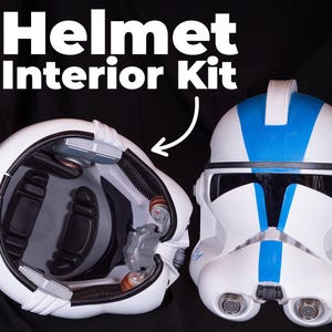 May include: A white helmet with a blue stripe and a black visor. The helmet is open to show the interior, which includes a black foam padding and a gray plastic piece. The text "Helmet Interior Kit" is written above the image.