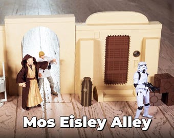 May include: A Star Wars themed playset featuring a beige building with a brown door and a white stormtrooper figurine. The set also includes two figures in brown and beige robes, and a brown and beige can.