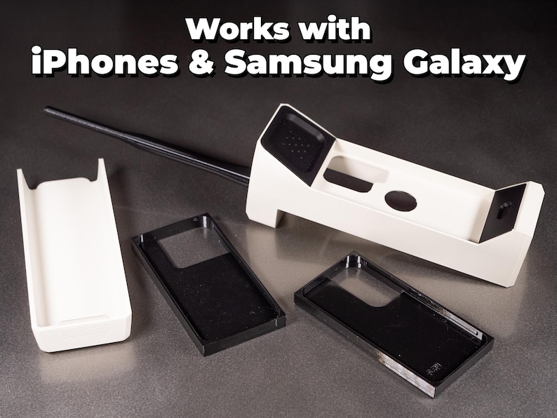 May include: A white plastic phone case with a black antenna and a black phone case insert. The text "Works with iPhones & Samsung Galaxy" is displayed at the top of the image.
