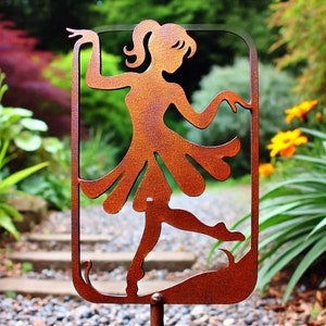 May include: A rusty metal silhouette of a dancing woman with a flowing skirt. The silhouette is mounted on a metal stake for outdoor garden decor.