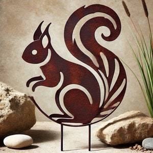 May include: A rusty brown metal squirrel silhouette garden stake. The squirrel is standing on a curved base with a decorative tail.