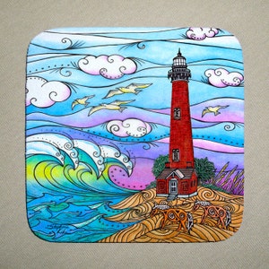 May include: Watercolor painting of a red lighthouse on a sandy beach with blue waves crashing in the background. The sky is blue with white clouds and there are birds flying overhead. The lighthouse has a white door and windows. The painting is signed "Stephanie Kiker" in the bottom left corner.