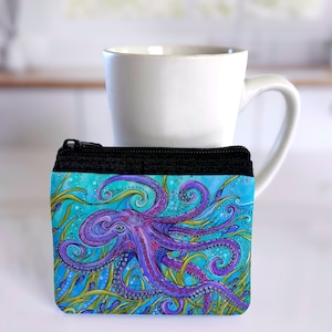 May include: A small zippered pouch with a colorful octopus design. The octopus is purple and pink with blue and green accents. The background is a turquoise blue with green seaweed.