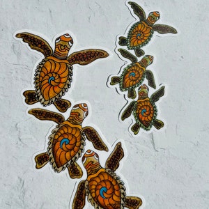 May include: Five colorful turtle stickers with intricate designs. The turtles are in various sizes and are arranged in a cascading pattern. The stickers are on a white background.