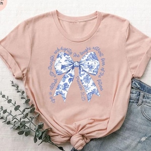 She is Clothed with Strength T-shirt, Proverbs 31:25 Shirt,Blue Coquette Bow Shirt,Bible Verse Tee,Cute Christian Gift,Religious Woman Shirt