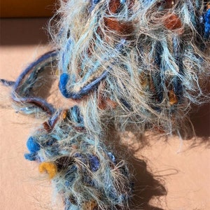 Handmade art yarns, blended fiber yarns, embroidery threads, decorative craft yarn, crochet art, textile embellishment thread