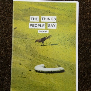 May include: A magazine cover with the title "THE THINGS PEOPLE SAY" in white block letters. The cover features a yellow and green background with a crow and a white, curved object. The issue number is "Issue #4".