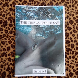May include: A magazine cover with a close-up of a shark underwater. The cover reads "The Things People Say" and "Issue #1".