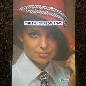 May include: A magazine cover featuring a woman wearing a red and white hat with the text "THE THINGS PEOPLE SAY" and "ISSUE #5".