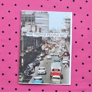 May include: A vintage magazine cover with a photo of a busy street scene in a city. The cover is titled "The Things People Say" and has the number "#7" in the top right corner.