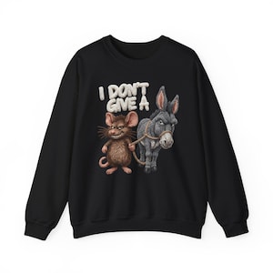 May include: Black sweatshirt featuring a graphic of a mouse holding a rope attached to a donkey. The text "I DON'T GIVE A" is above the animals in white. The mouse is brown and the donkey is gray.
