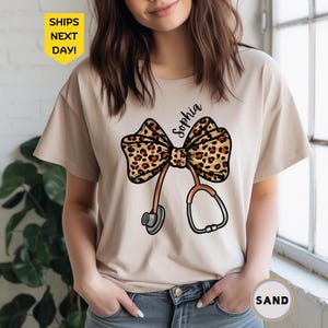 Personalizable Coquette Nurse Shirt, Leopard Print Stethoscope Bow, Healthcare Shirt, Nurse Graduation Shirt, T-Shirt, Gift for Nurse